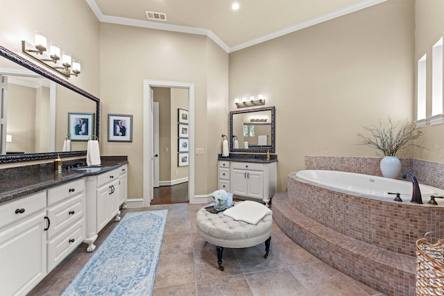 406 Wyndemere Blvd, Heath, TX 75032 - bathroom with two vanities, ornamental molding, a bath, and tile patterned floors
