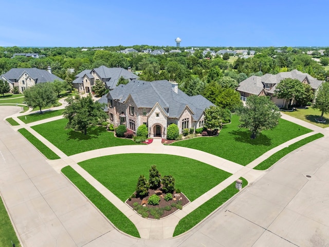 406 Wyndemere Blvd, Heath, TX 75032 - view of front of house featuring stone siding, curved driveway, a residential view, and a front lawn