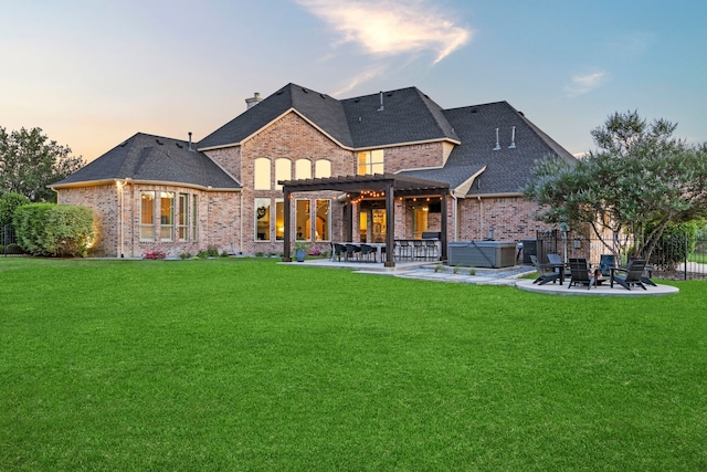406 Wyndemere Blvd, Heath, TX 75032 - back of house at dusk featuring a hot tub, a patio, brick siding, and a pergola