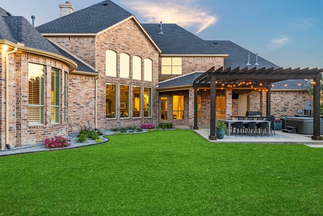 406 Wyndemere Blvd, Heath, TX 75032 - back of property at dusk with a pergola, roof with shingles, brick siding, a patio area, and a yard