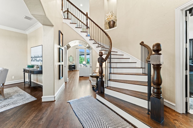 406 Wyndemere Blvd, Heath, TX 75032 - foyer with ornamental molding, wood finished floors, arched walkways, stairway, and baseboards