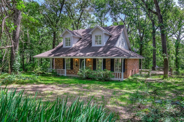 221 County Road 1946, Emory, TX 75440 - new england style home with brick siding and a porch