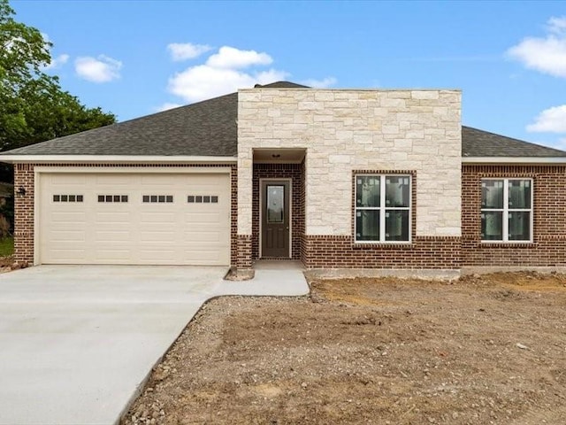 2799 Fm-3218, Commerce, TX 75428 - view of front of property featuring concrete driveway, an attached garage, a shingled roof, and brick siding