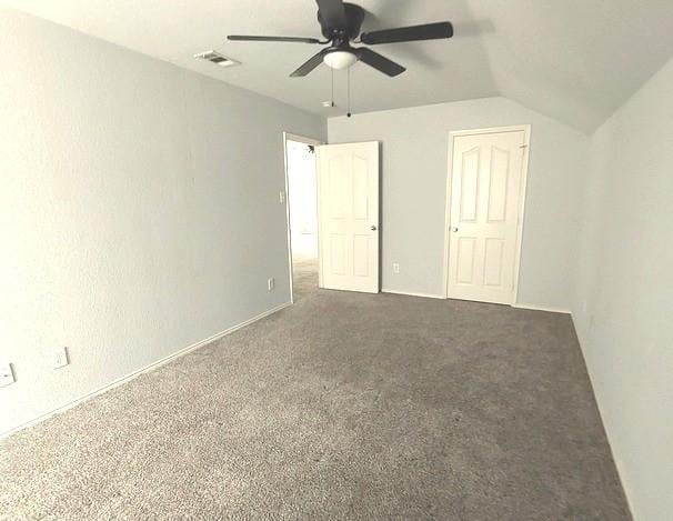1207 Goldeneye, Aubrey, TX 76227 - unfurnished bedroom with lofted ceiling, carpet, and a ceiling fan