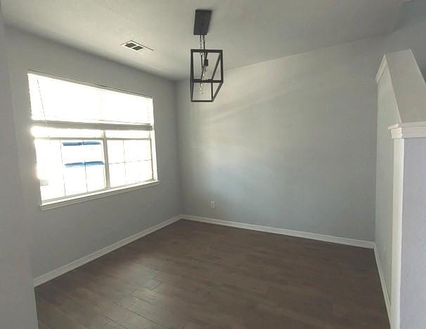 1207 Goldeneye, Aubrey, TX 76227 - unfurnished dining area featuring dark wood finished floors and baseboards