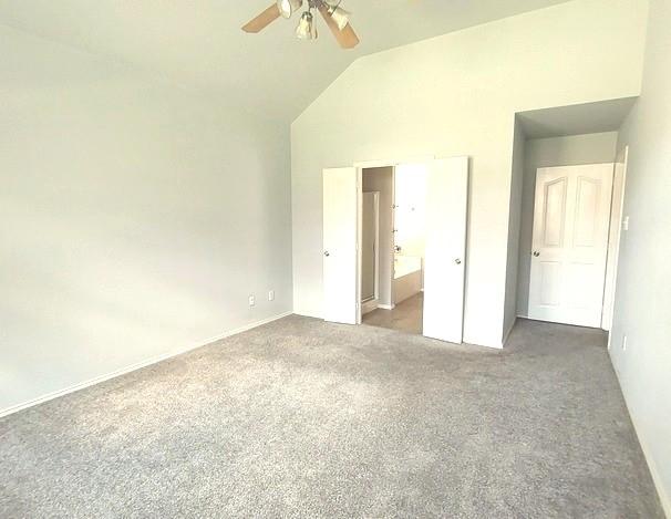 1207 Goldeneye, Aubrey, TX 76227 - unfurnished bedroom with lofted ceiling, carpet flooring, connected bathroom, and ceiling fan
