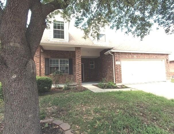 1207 Goldeneye, Aubrey, TX 76227 - view of front of home with brick siding, concrete driveway, a garage, and a front yard
