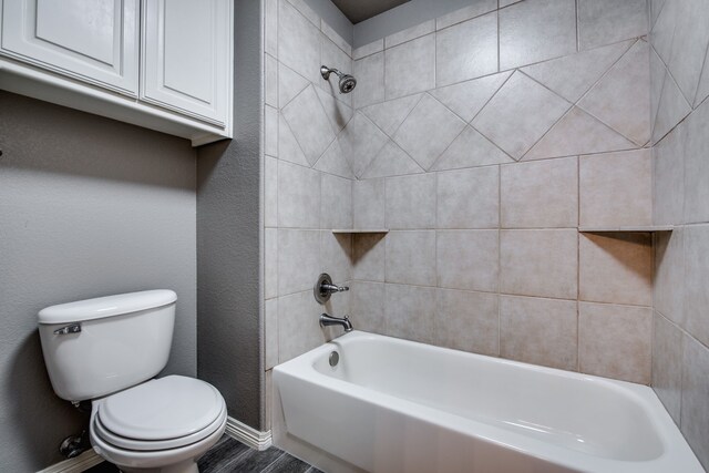 3317 S Riley Ct, Hurst, TX 76054 - bathroom featuring toilet, shower / bathtub combination, wood finished floors, and baseboards