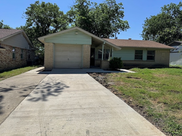 3422 Palm Dr, Mesquite, TX 75150 - ranch-style home with brick siding, concrete driveway, a garage, and a front yard