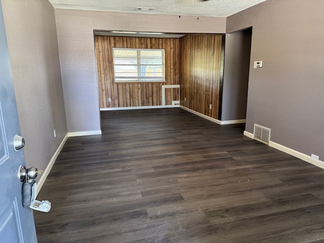 3422 Palm Dr, Mesquite, TX 75150 - empty room with baseboards, dark wood finished floors, and a textured ceiling