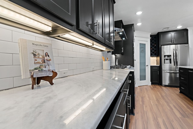 5316 Humbert Ave, Fort Worth, TX 76107 - kitchen with appliances with stainless steel finishes, dark cabinets, decorative backsplash, light stone counters, and recessed lighting