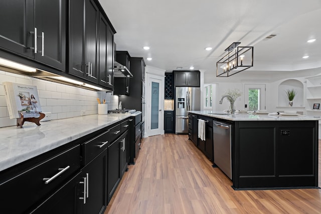 5316 Humbert Ave, Fort Worth, TX 76107 - kitchen with dark cabinetry, stainless steel appliances, a sink, light wood-type flooring, and recessed lighting