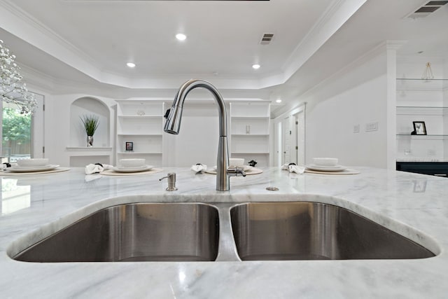 5316 Humbert Ave, Fort Worth, TX 76107 - kitchen view of light stone counters, a sink, crown molding, a raised ceiling, and recessed lighting