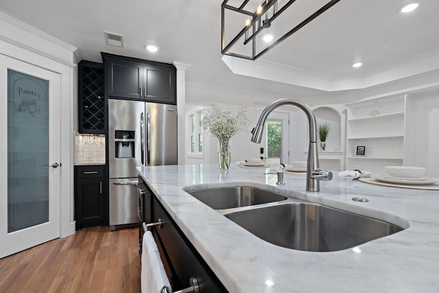 5316 Humbert Ave, Fort Worth, TX 76107 - kitchen featuring stainless steel fridge, a sink, ornamental molding, light stone counters, and wood finished floors