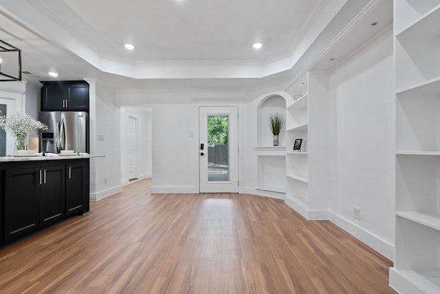 5316 Humbert Ave, Fort Worth, TX 76107 - unfurnished living room featuring light wood finished floors, built in features, baseboards, crown molding, and a raised ceiling