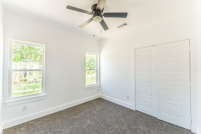 128 Goodman St, Sulphur Springs, TX 75482 - unfurnished bedroom featuring dark carpet, baseboards, a closet, and ceiling fan