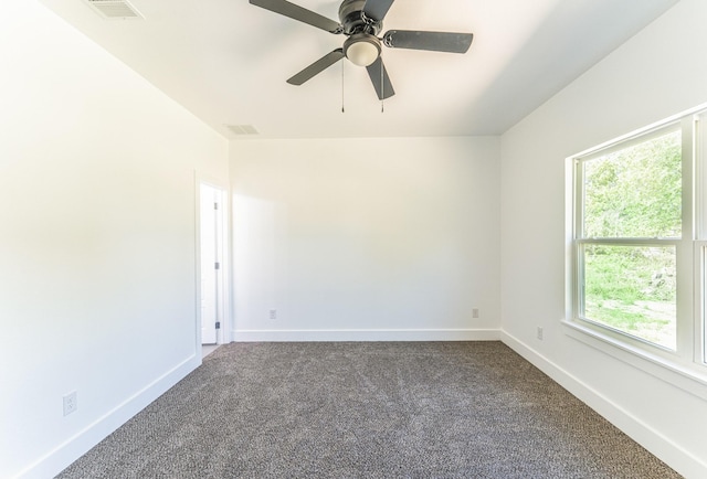 128 Goodman St, Sulphur Springs, TX 75482 - empty room featuring dark colored carpet, baseboards, and a ceiling fan