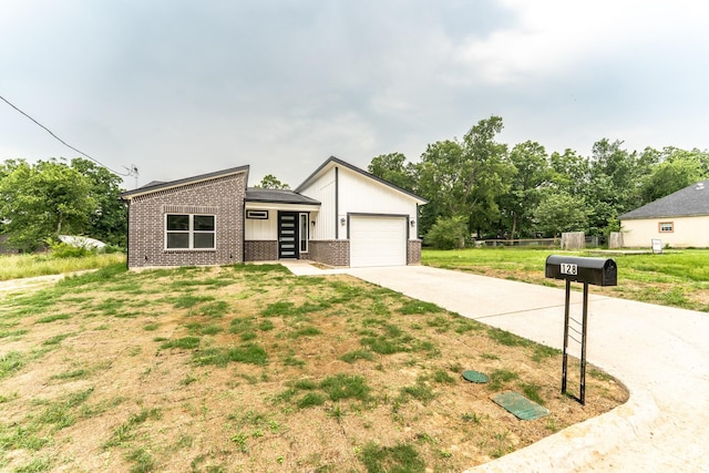 128 Goodman St, Sulphur Springs, TX 75482 - mid-century home with brick siding, concrete driveway, an attached garage, a front yard, and board and batten siding