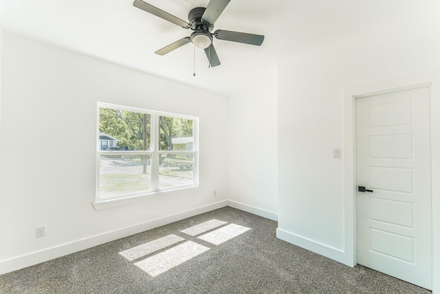 128 Goodman St, Sulphur Springs, TX 75482 - spare room featuring dark carpet, baseboards, and ceiling fan