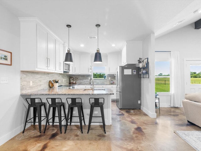 431 Advance Rd, Weatherford, TX 76088 - kitchen with appliances with stainless steel finishes, a peninsula, backsplash, white cabinetry, and recessed lighting