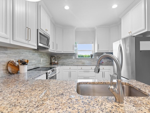 431 Advance Rd, Weatherford, TX 76088 - kitchen with appliances with stainless steel finishes, a sink, white cabinetry, decorative backsplash, and recessed lighting
