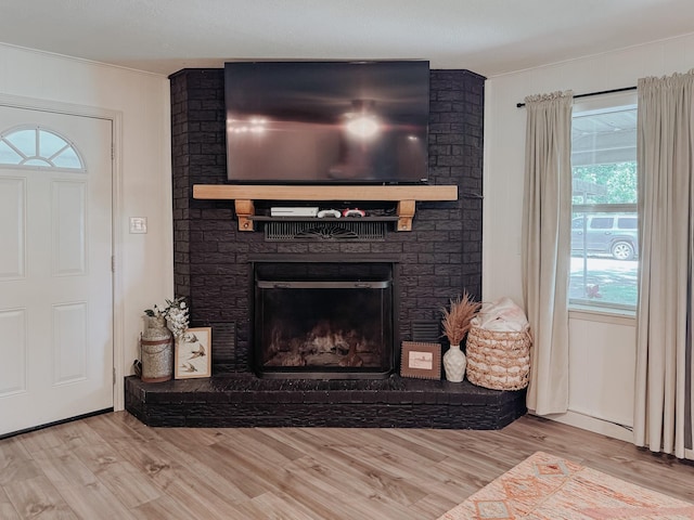 461 E Bradley St, Fairfield, TX 75840 - living area with wood finished floors, a brick fireplace, and crown molding