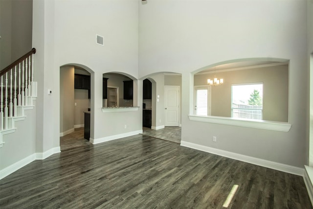 3613 Pisa Mews, Dallas, TX 75236 - unfurnished living room with a high ceiling, dark wood-style floors, baseboards, and a chandelier