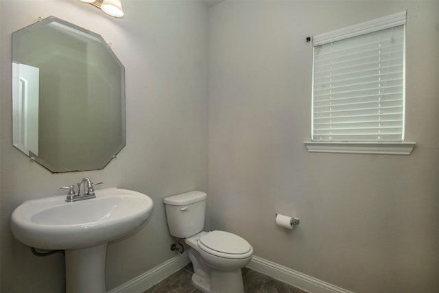 3613 Pisa Mews, Dallas, TX 75236 - half bath featuring baseboards, toilet, and tile patterned floors