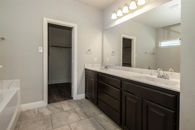 3613 Pisa Mews, Dallas, TX 75236 - full bathroom with double vanity, a bath, a spacious closet, tile patterned flooring, and baseboards