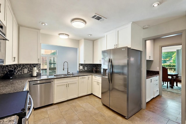 7109 Alpha Rd, Dallas, TX 75240 - kitchen featuring stainless steel appliances, a sink, healthy amount of natural light, tasteful backsplash, and recessed lighting