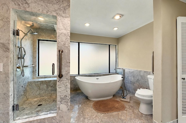 7109 Alpha Rd, Dallas, TX 75240 - bathroom with a shower stall, tile walls, a freestanding bath, marble finish floors, and toilet