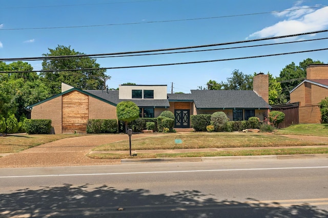 7109 Alpha Rd, Dallas, TX 75240 - mid-century inspired home featuring a front yard and a shingled roof