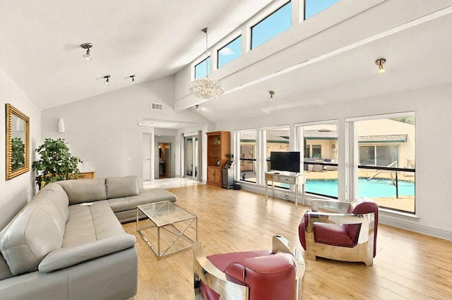 7109 Alpha Rd, Dallas, TX 75240 - living room with light wood-style floors and high vaulted ceiling