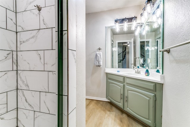 2 Linderhof Cir, Bedford, TX 76022 - full bathroom featuring wood finished floors, vanity, and a textured wall