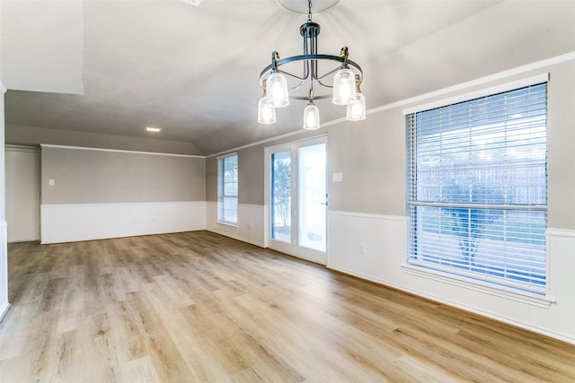 2 Linderhof Cir, Bedford, TX 76022 - spare room featuring wood finished floors, a chandelier, a wainscoted wall, and lofted ceiling