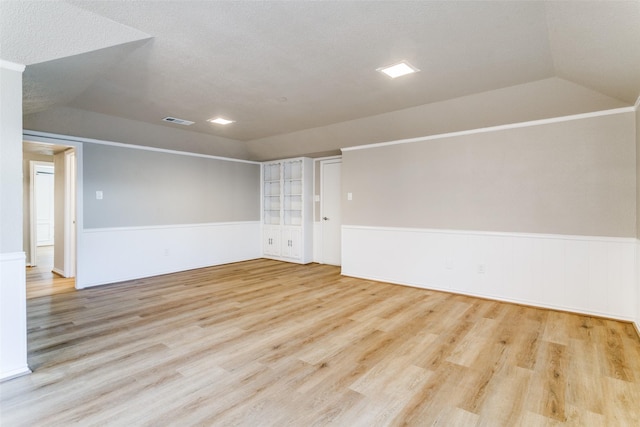 2 Linderhof Cir, Bedford, TX 76022 - spare room with vaulted ceiling, wood finished floors, and wainscoting