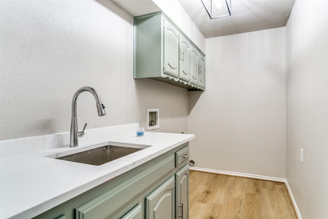 2 Linderhof Cir, Bedford, TX 76022 - laundry area featuring cabinet space, hookup for a washing machine, light wood-style flooring, and baseboards