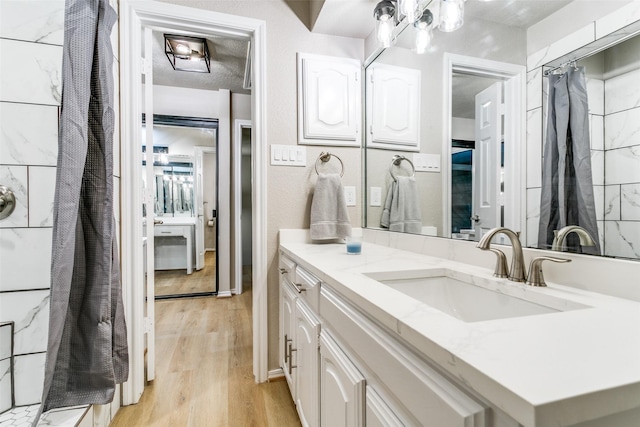 2 Linderhof Cir, Bedford, TX 76022 - bathroom featuring wood finished floors, vanity, and curtained shower