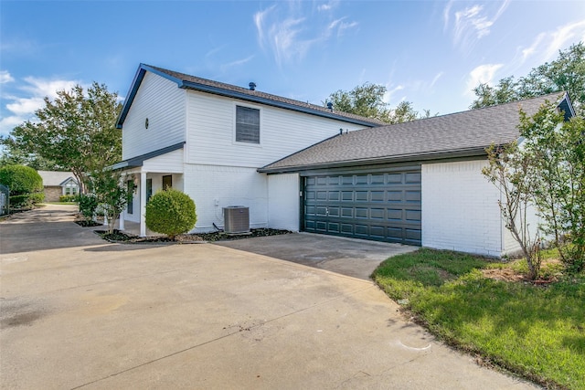 2 Linderhof Cir, Bedford, TX 76022 - view of home's exterior featuring brick siding, driveway, an attached garage, and central AC unit
