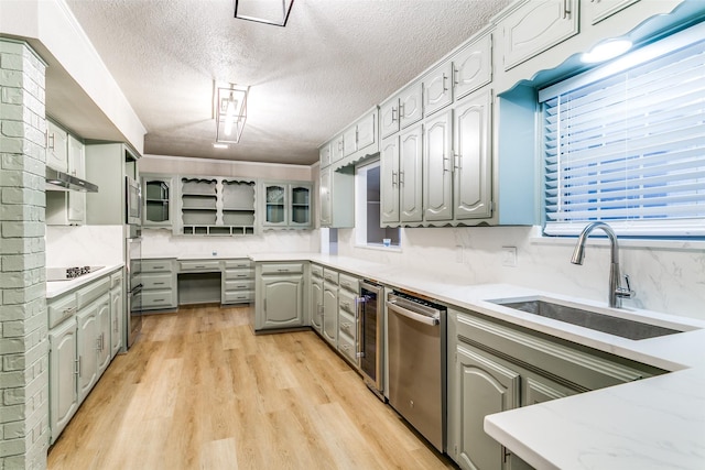 2 Linderhof Cir, Bedford, TX 76022 - kitchen with gray cabinets, appliances with stainless steel finishes, a sink, a textured ceiling, and light wood-style floors