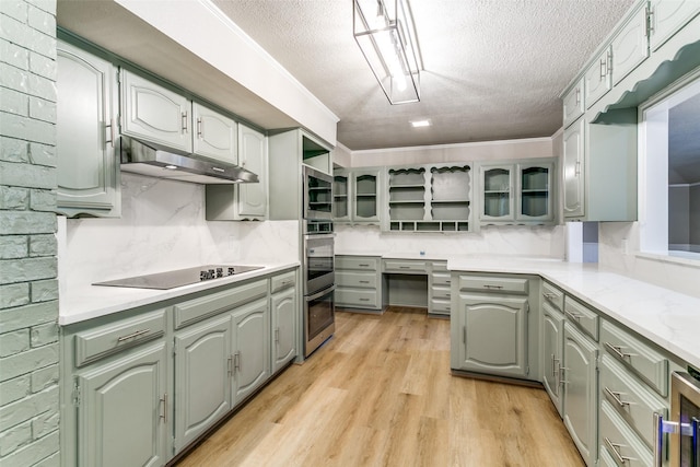 2 Linderhof Cir, Bedford, TX 76022 - kitchen with under cabinet range hood, open shelves, a textured ceiling, stainless steel appliances, and light wood-style floors