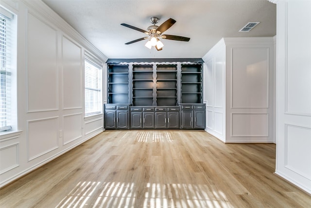 2 Linderhof Cir, Bedford, TX 76022 - empty room with a decorative wall, a ceiling fan, and light wood-type flooring