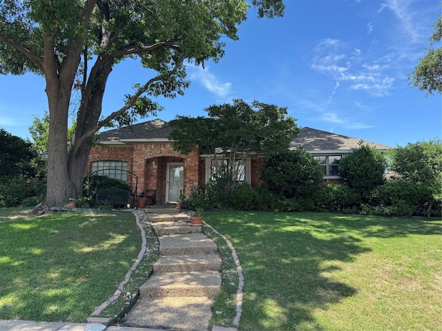 2317 Cliffside Dr, Plano, TX 75023 - view of front facade featuring a front yard, brick siding, and a shingled roof