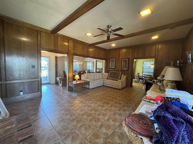 2317 Cliffside Dr, Plano, TX 75023 - tiled living room featuring wood walls, a ceiling fan, beam ceiling, and a decorative wall