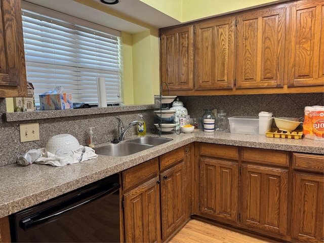 2317 Cliffside Dr, Plano, TX 75023 - kitchen featuring dishwasher, a sink, tasteful backsplash, and brown cabinetry