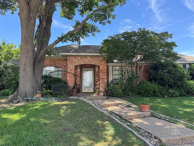 2317 Cliffside Dr, Plano, TX 75023 - view of front facade with a front lawn, brick siding, and roof with shingles