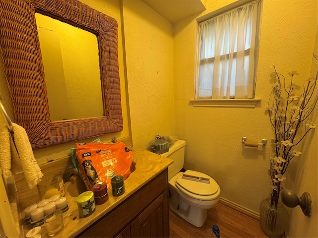2317 Cliffside Dr, Plano, TX 75023 - bathroom with toilet, vanity, and wood finished floors