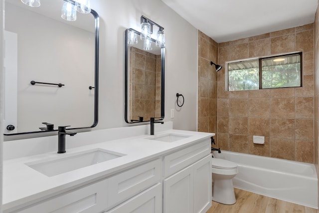 3562 Bent Oak St E, Greenville, TX 75401 - full bathroom featuring toilet, double vanity, tub / shower combination, and wood finished floors