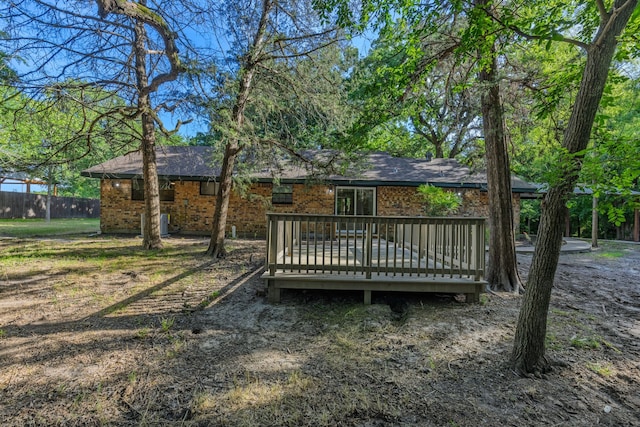 3562 Bent Oak St E, Greenville, TX 75401 - back of house with brick siding, a wooden deck, and roof with shingles
