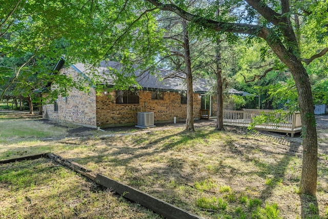 3562 Bent Oak St E, Greenville, TX 75401 - view of yard featuring central AC and a deck